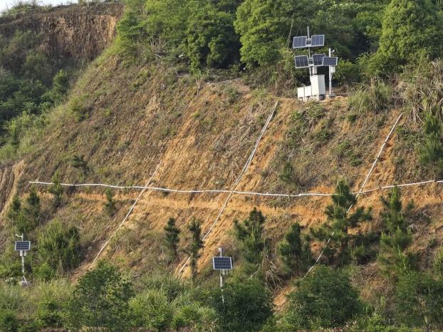 Slope monitoring site: solar-powered station and cross-slope cabling
